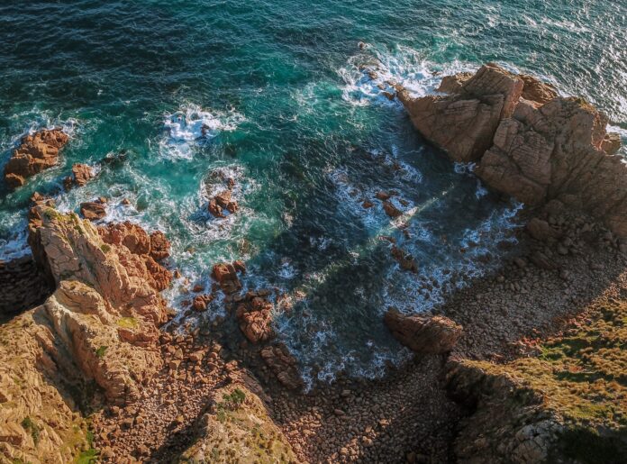 a rocky beach with blue water