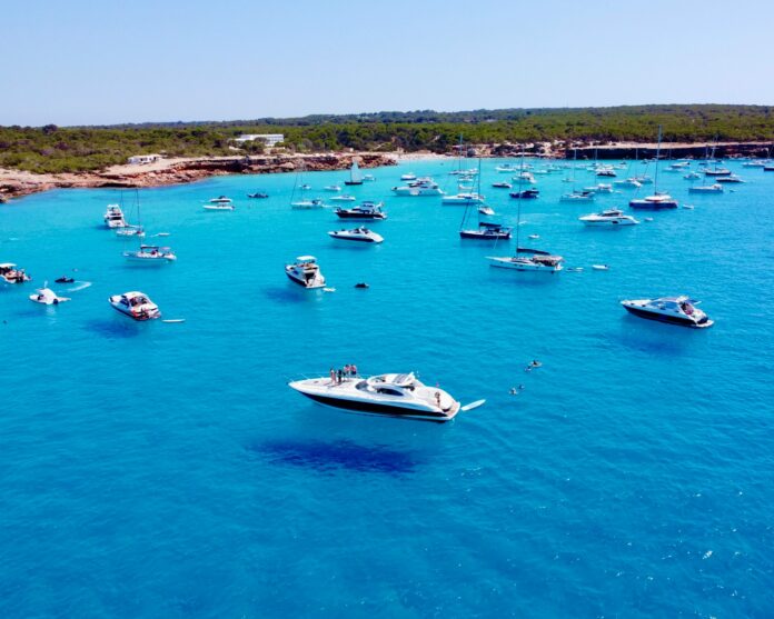 a group of boats floating on top of a body of water